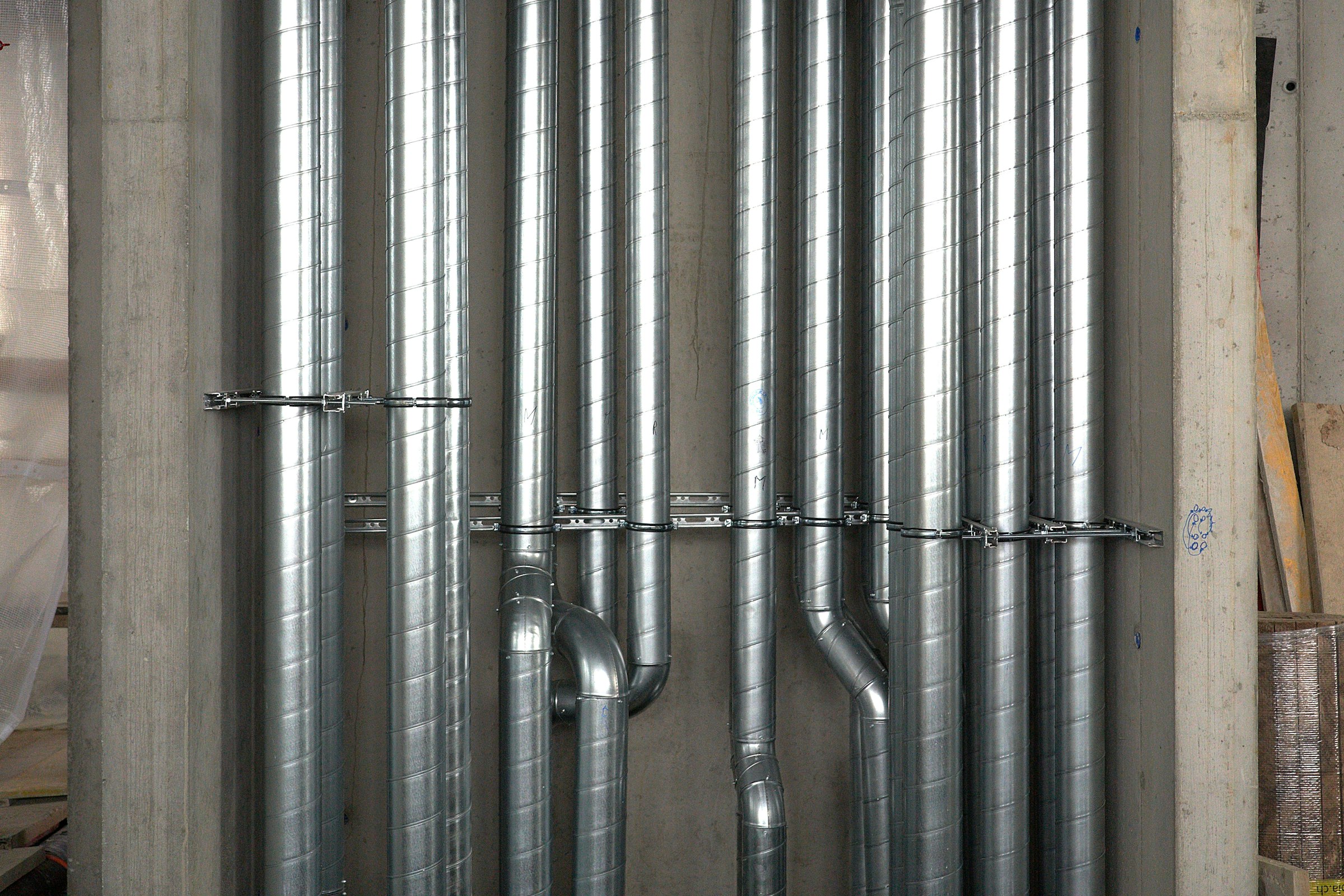 Exposed services and pipework running through a building riser