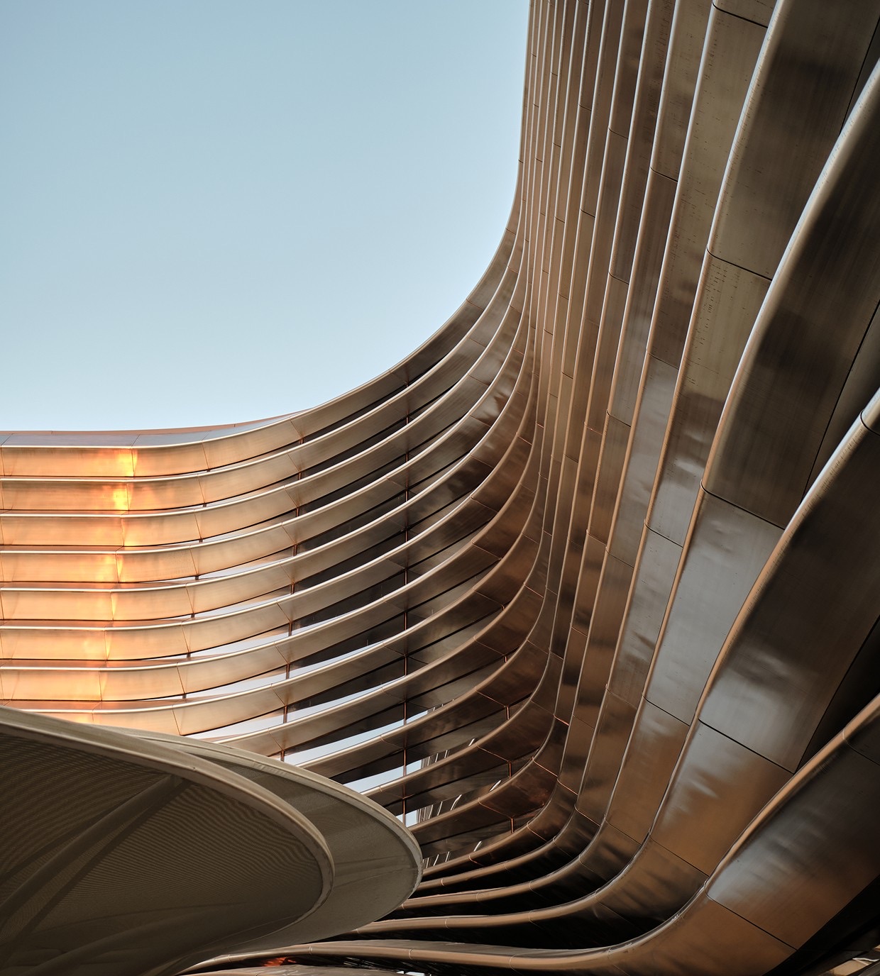 Curved bronze facade of a contemporary building